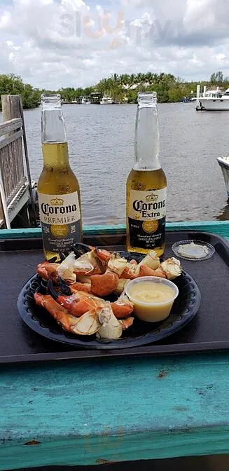 Stone crab claws and two beers on a dockside table