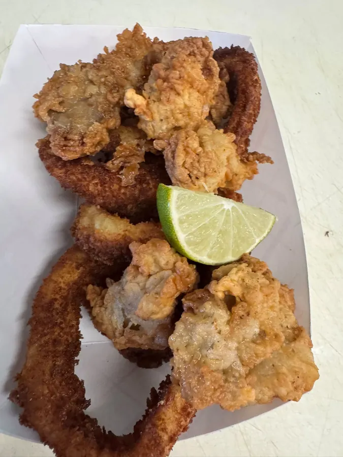 A fried seafood basket with lime
