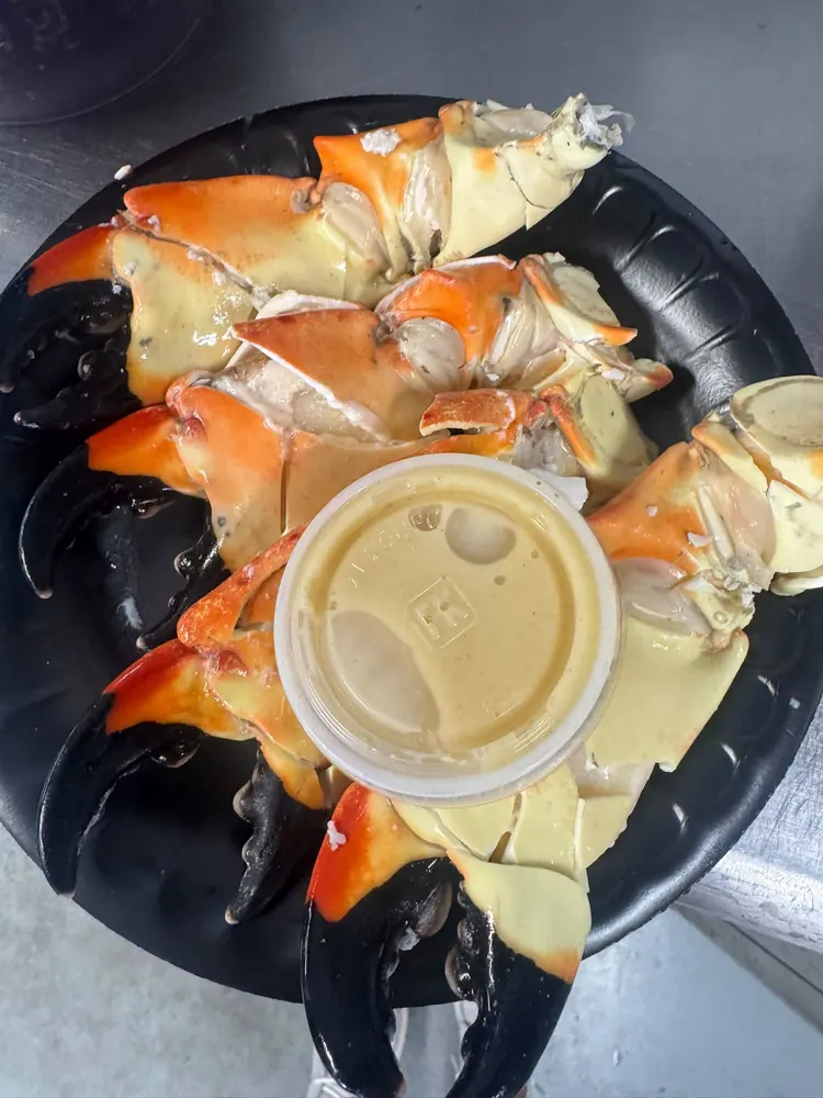 A platter of stone crab claws with dipping sauce