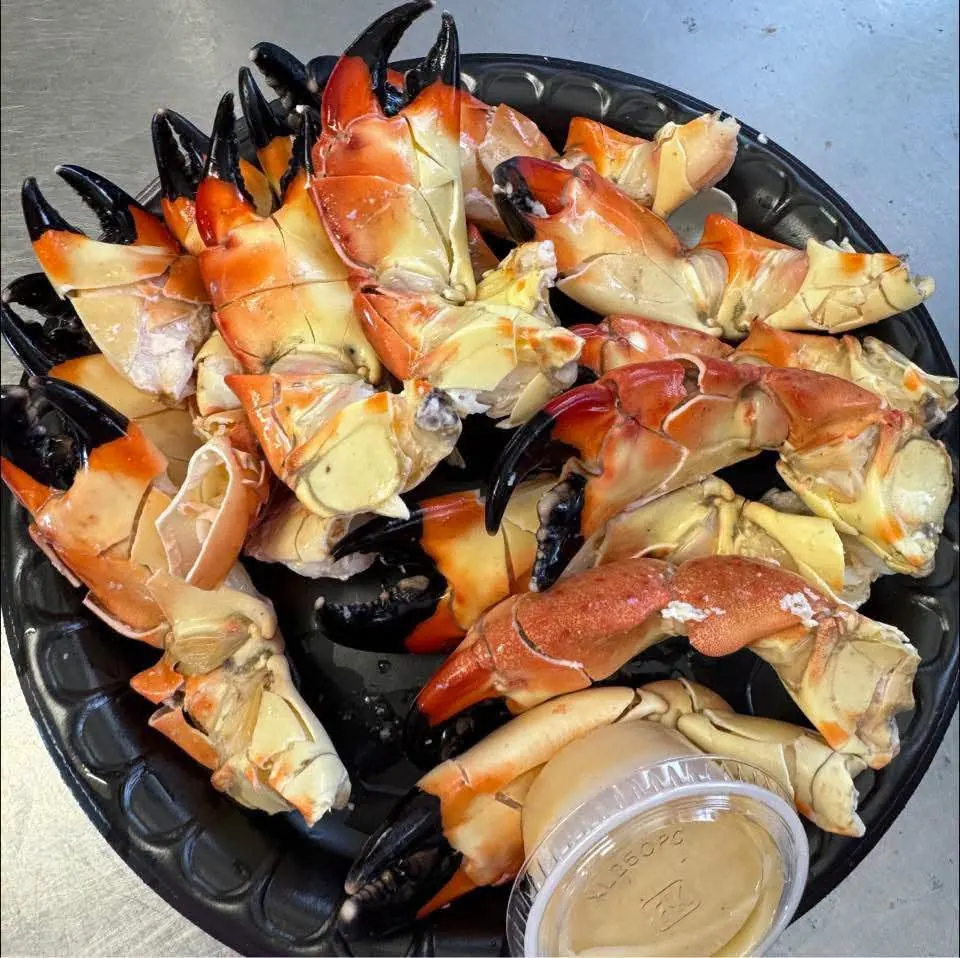 A platter of stone crab claws with mustard sauce